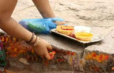 Hindu devotees apply kumkum and turmeric a tradition  to the temple steps 
