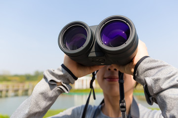 Young woman use of the binocular