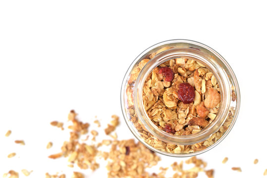 Granola with honey, oatmeal, cashew nut, almond, raisin and cranberry on white background