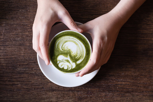 matcha green tea latte on wooden background