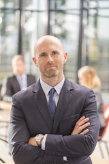 manager at the office with a group behind him