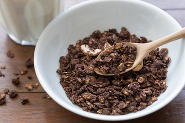 granola in a bowl on wooden table