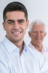 Smiling young man with grandfather