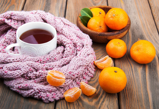 Cup of tea with scarf and tangerines