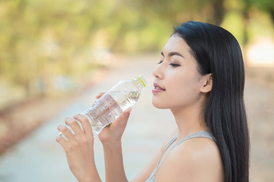Woman drinking water from Bottle