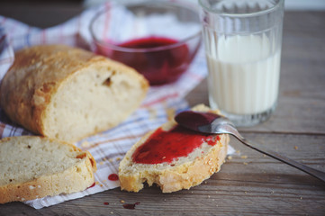 Bread with homemade jam in plate on wooden table, closeup