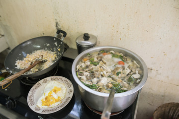 Old Woman Preparing food for thai food cooking in a old kitchen

