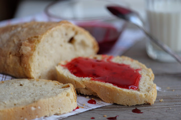 Bread with homemade jam in plate on wooden table, closeup