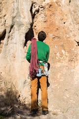 Fototapeta na wymiar Young male climber hanging by a cliff.