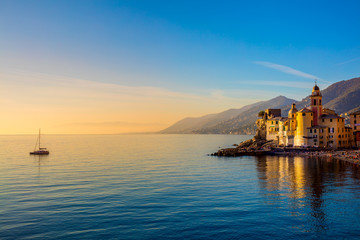 Fototapeta na wymiar Mediterranean Sea at sunrise, small old town and yacht -