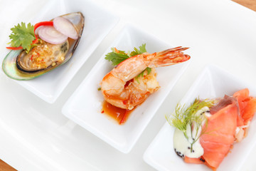 mussels, shrimps and ham with sauce served in modern style. thai