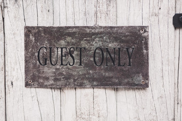 Guest only sign on the wooden door