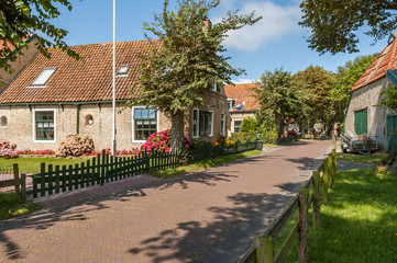 Street with old Dutch commander houses in the town of Hollum on the West-Frisian island Ameland,...