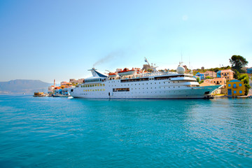 Naklejka premium Ferry boat arriving to the sea port of Greek island Kastellorizo. Greece