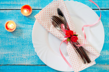 Romantic table setting for Valentine's day - candles, plate, kni