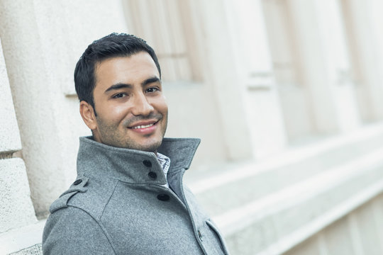 Close-up of a happy smile man wearing coat, coldly morning. Autmn day