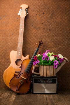 Violin, guitar and radio on still-life old steel background