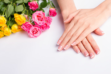 French manicure with pink and yellow roses on a white background - 99348429