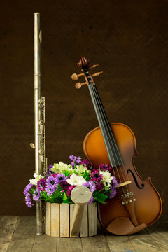Silver flute and violin on old steel background