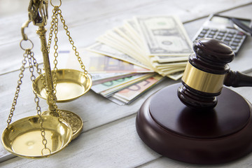 Labor law concept, scale, gavel, money and calculator