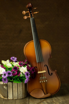 Vintage violin with old steel background with flower