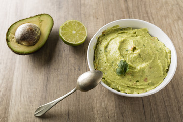 Guacamole with avocado, lime, tomato, and cilantro