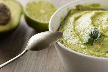 Guacamole with avocado, lime, tomato, and cilantro
