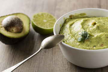 Guacamole with avocado, lime, tomato, and cilantro