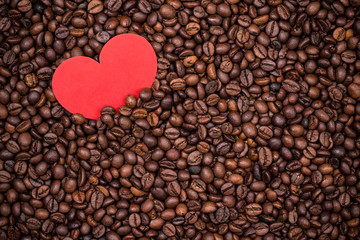 Coffee beans with red paper heart