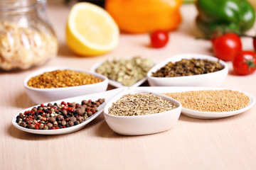 Variety of spices in ceramic containers on the kitchen table