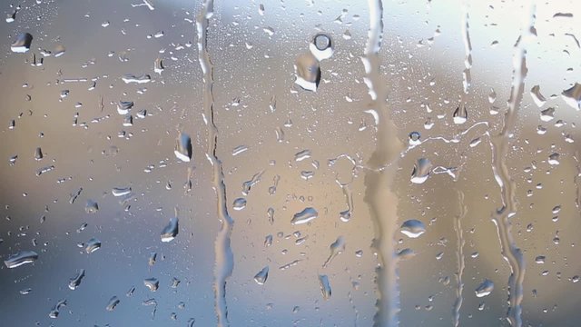 Lovely raindrops on window at rainy day.