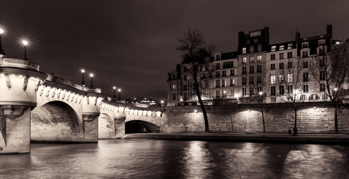 Fototapeta Paris illuminated bridge and buildings at night.  Pont Neuf. Black and white. 