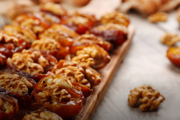 Walnut, date fruit on wooden table, close-up