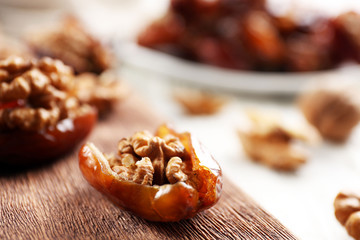 Walnut in date fruit on cutting board, close-up