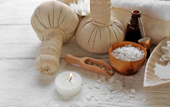Spa composition and treatments on light wooden background, close-up