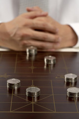 Office worker playing Chinese chess with investment capital