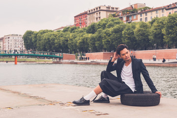 Handsome Asian model posing by an artificial basin