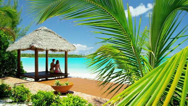 Caucasian couple outdoors in a tropical beach hut 