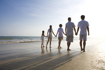 Portrait of a family walking along the beach