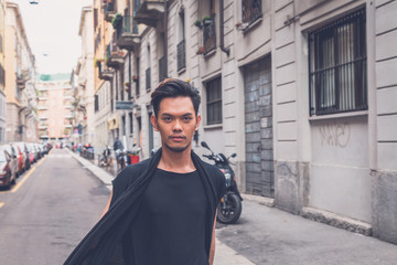 Fototapeta na wymiar Handsome Asian model posing in the city streets