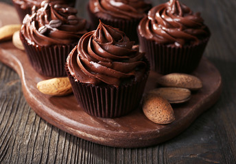 Chocolate cupcakes with nuts on cutting board