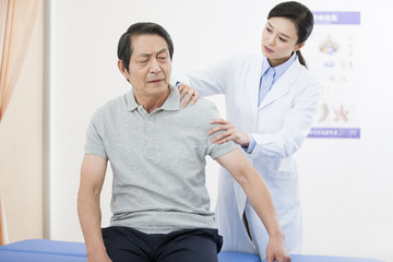 Female doctor examining senior patient