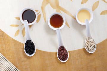 Obraz na płótnie Canvas Chinese Medicine in Spoons Resting on Teacups