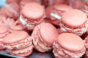 Pink macaroons on plate closeup