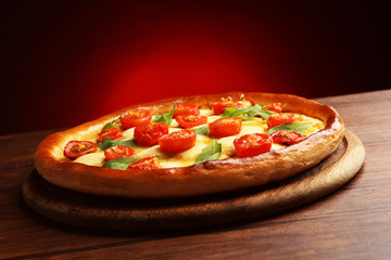 Pizza Margherita with arugula on dark red background