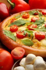 Pizza Margherita with arugula and vegetables, close-up