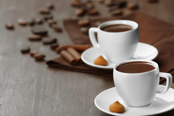 Cacao with sweets and cinnamon on cutting board