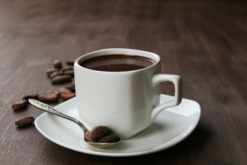 Cacao with beans and chocolate on wooden background