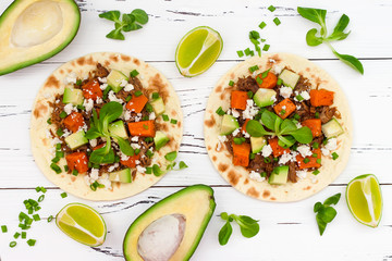 Mexican tacos with meat, sweet potatoes and cotija cheese