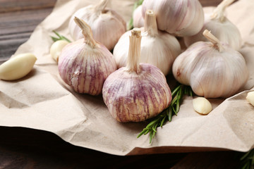 Composition of garlic and rosemary on the paper, close up
